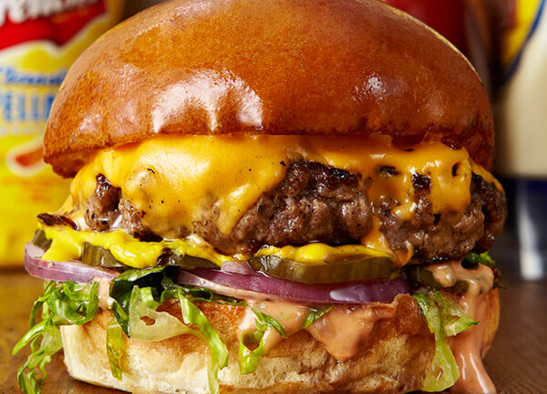 Beef burger with melted cheese and bacon