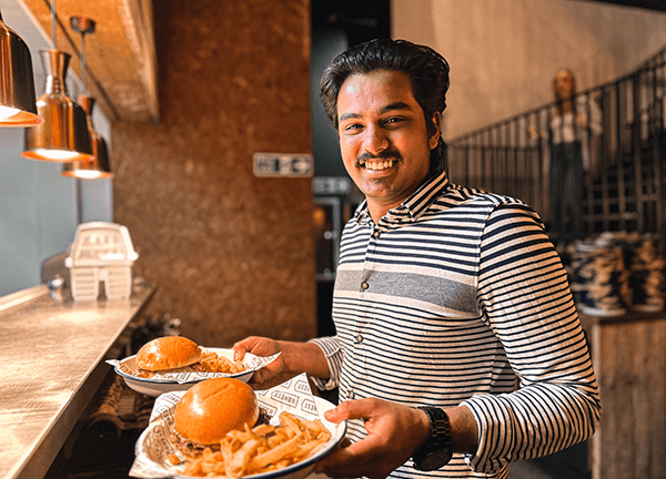 Waiter with burgers